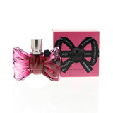 Pink perfume bottle with black bow design and matching box 